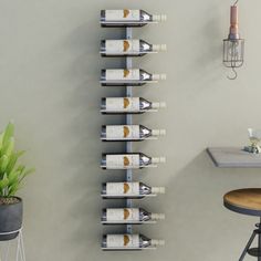 a wall mounted wine rack filled with bottles next to a bar stool and potted plant