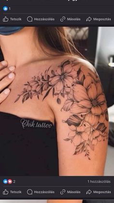 the back of a woman's shoulder with flowers and leaves tattoo on her arm