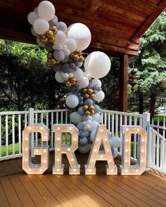 an image of balloons that spell out the word grad in front of a porch