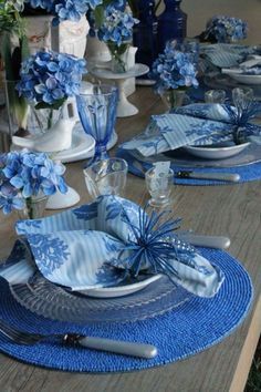 the table is set with blue and white dishes