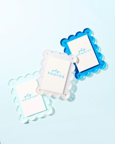 two blue and white photo frames sitting next to each other