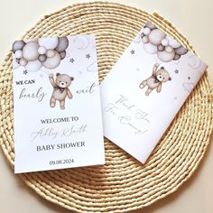 two baby shower cards sitting on top of a wicker basket next to each other