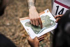 two people are pointing at a map together