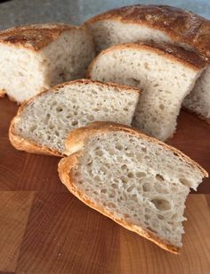 several pieces of bread sitting on top of a wooden cutting board