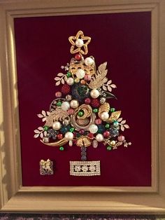 a christmas tree made out of ornaments in a frame