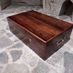 a wooden box sitting on top of a stone floor