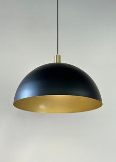 a black and gold light hanging from a ceiling