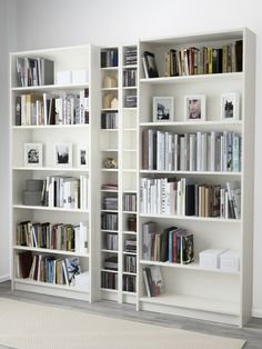 a white bookshelf filled with lots of books on top of it's shelves