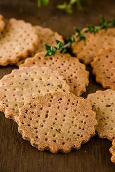 crackers are arranged on a table with parsley sprigs in the background