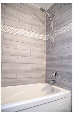 a white bath tub sitting next to a shower head