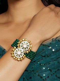 Alluring Green & Golden Polki Bracelet - Joules By Radhika This designer kundan polki bracelet is completed with rich green agate beads & fresh water pearls. Ideal to be worn on party, festive or wedding occassions on your Indian or fusion attire. Every artistic piece from Joules by Radhika is made with real semi precious stones only, giving it a regal look & feel. SET INCLUDES: Bracelet Details: Handcrafted with ❤️ Metal: Brass Product Type: Bracelet Stone: Hydro Polkis, Green Agate Beads, Gold Temple Jewelry Bracelets With Stone Work For Party, Fusion Style Kundan Bracelets With Cutdana, Green Jewelry With Gota Work For Celebration, Green Beaded Bracelets For Festive Occasions, Kundan Pearl Bracelet For Festivals, Kundan Pearl Bracelet For Festivals And Gifts, Adjustable Green Jewelry For Diwali, Diwali Party Bracelets With Tilla Work, Bollywood Style Tilla Bracelets For Party