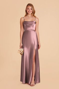 a bridesmaid in a long, satin gown with side slit and spaghetti straps