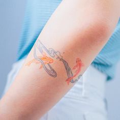 a woman with a tattoo on her arm