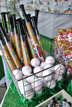 a basket filled with baseballs sitting on top of a table next to other items