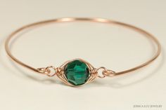 Rose Gold Emerald Swarovski Crystal Bracelet Handmade by Jessica Luu Jewelry ~ Faceted ~ Versatile ~ Elegant ~ With every wave of your hand, there will be a sparkle of emerald green at your wrist as this bangle moves around. Emerald is the birthstone for May making this a thoughtful birthday gift for someone special. MATCHING ITEMS https://www.etsy.com/shop/JessicaLuuJewelry?search_query=emerald MATERIALS: ~ 10mm emerald Swarovski crystal ~ 14K gold filled wire HOW IT'S MADE: A large Swarovski c Rose Gold Wire Wrapped Bracelet, Wire Wrapped Rose Gold Bracelet, Elegant Handmade Crystal Bracelet, Elegant Hand Wrapped Crystal Bracelet, Elegant Hand-wrapped Crystal Bracelet, Adjustable Jewelry With May Birthstone, Rose Gold Bangle Bracelets For Jewelry Making, Adjustable May Birthstone Jewelry With Round Stone, Swarovski Crystal Bracelet