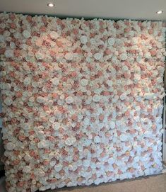 a wall made out of flowers in a room