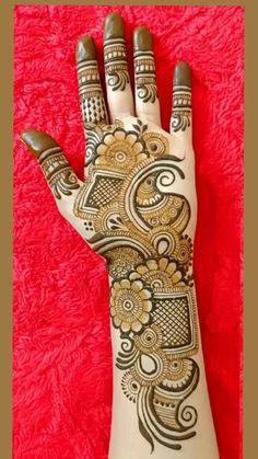 a hand with henna tattoos on it