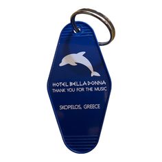 a blue key chain with a dolphin on it's side and the words hotel bella donna thank you for the music shopplos greece