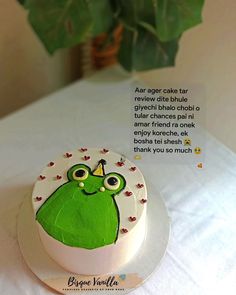 there is a cake with a green frog on it