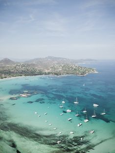 an aerial view of several boats in the water