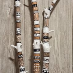 three white and brown decorative objects sitting on top of a wooden floor