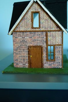 a small model house sitting on top of a table