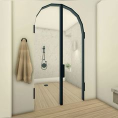 an open bathroom door with a towel hanging on the wall