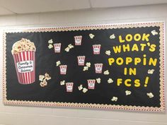 a chalkboard with popcorn and movie tickets on it that says, look what's popping in focs