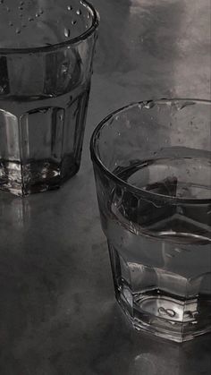 two clear glass cups sitting on top of a table