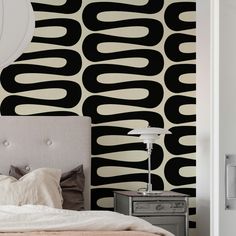 a bedroom with black and white wallpaper on the walls