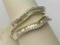 two white gold wedding rings with baguettes and diamonds on each band, set in 18k yellow gold