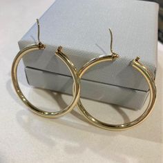 Up for sale is this pair of vintage estate 14 karat solid yellow gold large 1-3/8" (34mm) diameter high polish hollow 2mm tube hoop latch hinged snap earrings.  The closure is a hinged snap closure.  The earrings measure 1-3/4" in diameter.  The circular hollow tube measures 2mm wide.  The post of each earring is marked 14K.  The pair weighs 3.1 grams.  Some photos are enlarged to show details. Condition:  This pair of earrings is pre-owned and vintage and as-such, expect wear...  minor surface Earrings Vintage, Jewelry Earrings Hoops, Solid Yellow, Vintage Earrings, Jewelry Earrings, Hoop Earrings, Im Not Perfect, Yellow Gold, Yellow