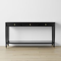 a black console table with two drawers on one side and gold handles on the other