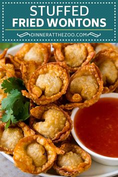 fried fried wontons on a plate with dipping sauce