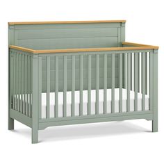 a baby crib with a wooden headboard and foot board on the bottom half