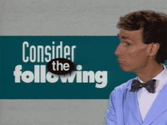 a man wearing a blue suit and bow tie standing in front of a sign that says consider the following