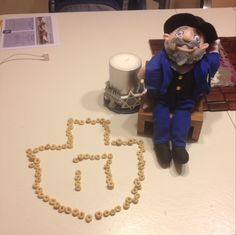 a table topped with a cake and a toy figure next to the word it spelled out