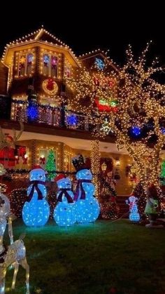 christmas lights decorate houses and lawns with snowmen