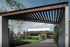 an entrance to a modern house with a pergolated roof