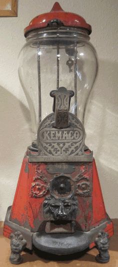 an old fashioned gummy machine sitting on top of a table