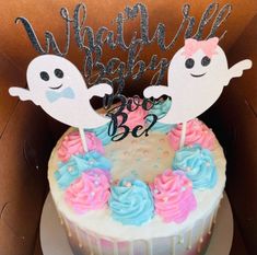 a birthday cake decorated with two ghostes and the words boo on top is in a box