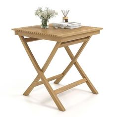 a small wooden table with flowers and books on the top, sitting against a white background