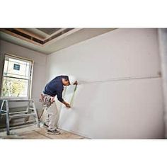 a man is painting the walls in his home