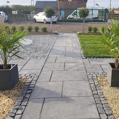 two planters are on the side of a walkway