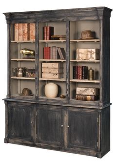 an old bookcase with many books on it's sides and shelves in the middle