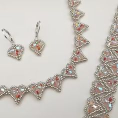 a necklace and earring set made out of swarozak crystal stones on a white background