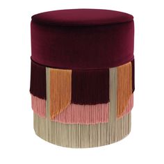 a round stool with fringes on the top and bottom in maroon, beige, yellow and pink