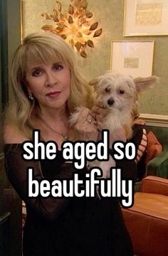 a woman holding a small white dog in her arms with the caption she aged so beautifully