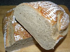 a loaf of bread sitting on top of a wooden cutting board