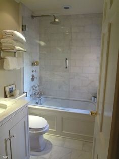 a bathroom with a toilet, sink and bathtub